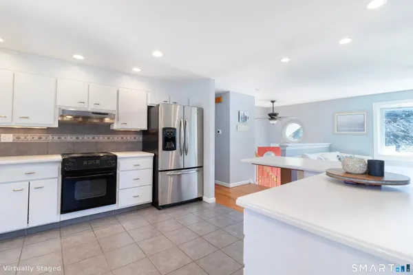 a kitchen that has a lot of cabinets in it and stainless steel appliances