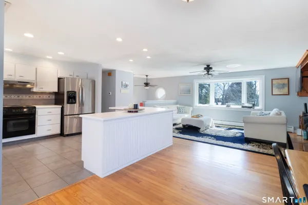 a kitchen with a refrigerator and a stove top oven