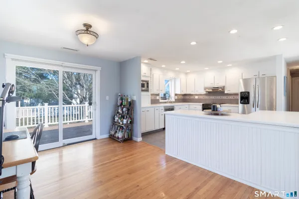 a kitchen with stainless steel appliances granite countertop a refrigerator and a stove top oven