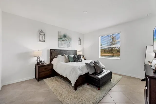 a bathroom with a granite countertop sink mirror vanity and toilet