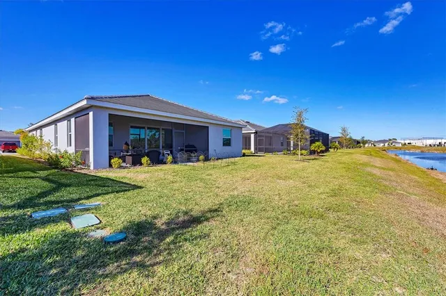 a view of a building with a yard and plants