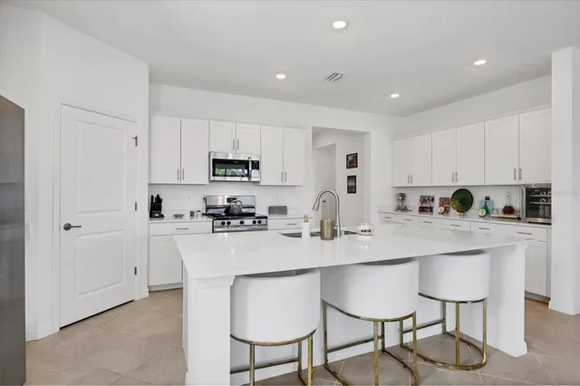 a kitchen that has a lot of cabinets in it and appliances