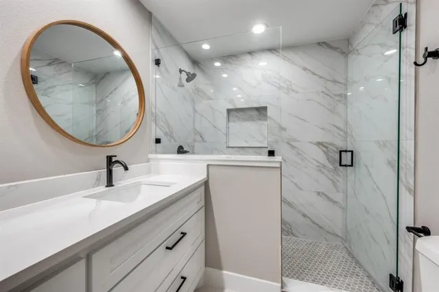 a bathroom with a sink a vanity and a mirror