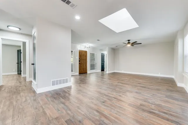 wooden floor in an empty room with a window