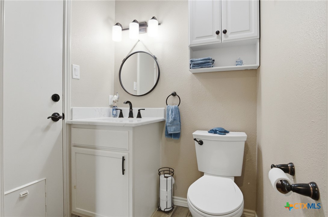 642 Phantom Rider Trail Spring Branch, TX 78070 - Photo 21 of 41 a bathroom with a toilet sink and mirror