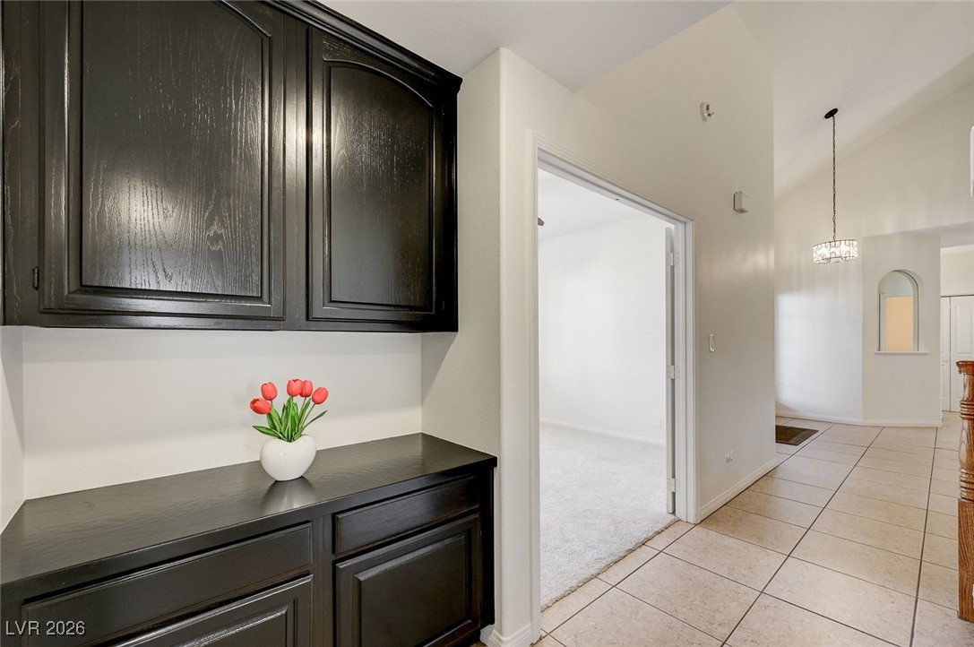 2955 El Camino Road Las Vegas, NV 89146 - Photo 61 of 99 Hallway featuring light tile patterned floors and high vaulted ceiling