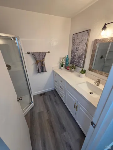 a bathroom with a double vanity sink and mirror