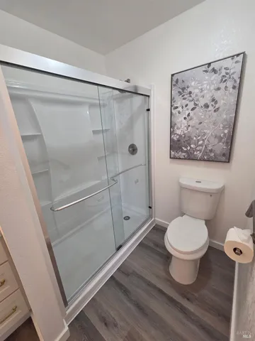 a bathroom with a toilet and a shower