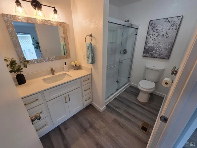 a bathroom with a double vanity sink toilet and shower
