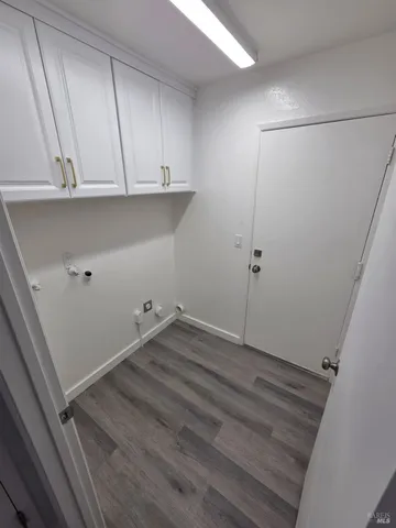 a view of a room with wooden floor and cabinets