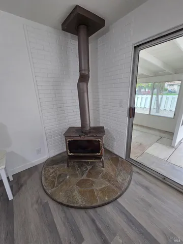 a view of a livingroom with a fireplace and window