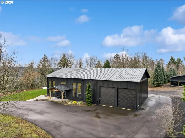 a view of a house with a patio and a yard