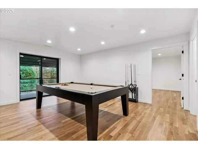 a view of a room with wooden floor electric appliances and windows