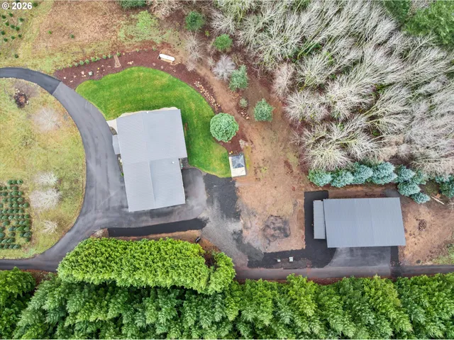 an aerial view of a house with a yard