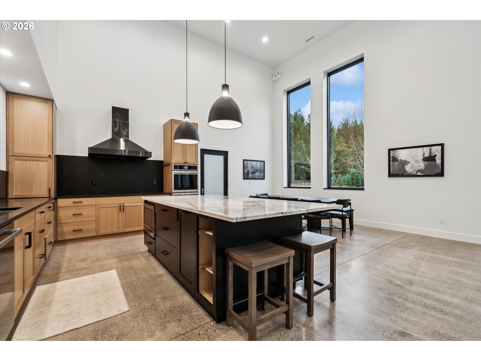 43815 Southeast Herrick Road Sandy, OR 97055 - Photo 8 of 35 a kitchen with stainless steel appliances kitchen island granite countertop a table chairs in it and wooden floors