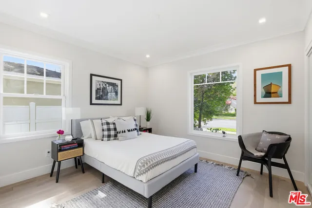 a bedroom with a bed a table and chair