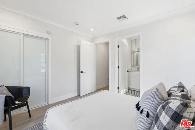 a bedroom with a bed and a chair