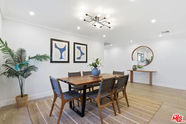 a view of a dining room with furniture and a chandelier