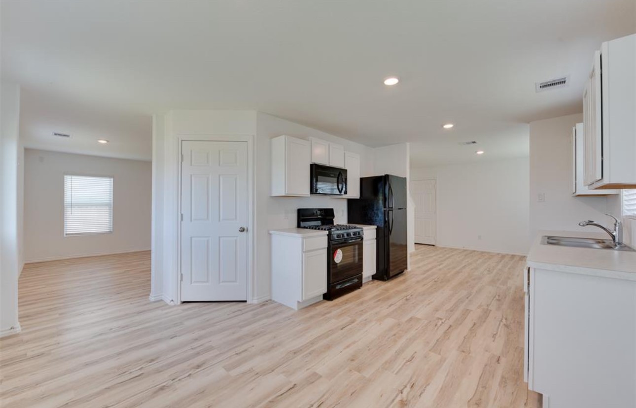 11020 South Lake Mist Lane Willis, TX 77318 - Photo 16 of 27 a kitchen with stainless steel appliances granite countertop a refrigerator and a stove top oven