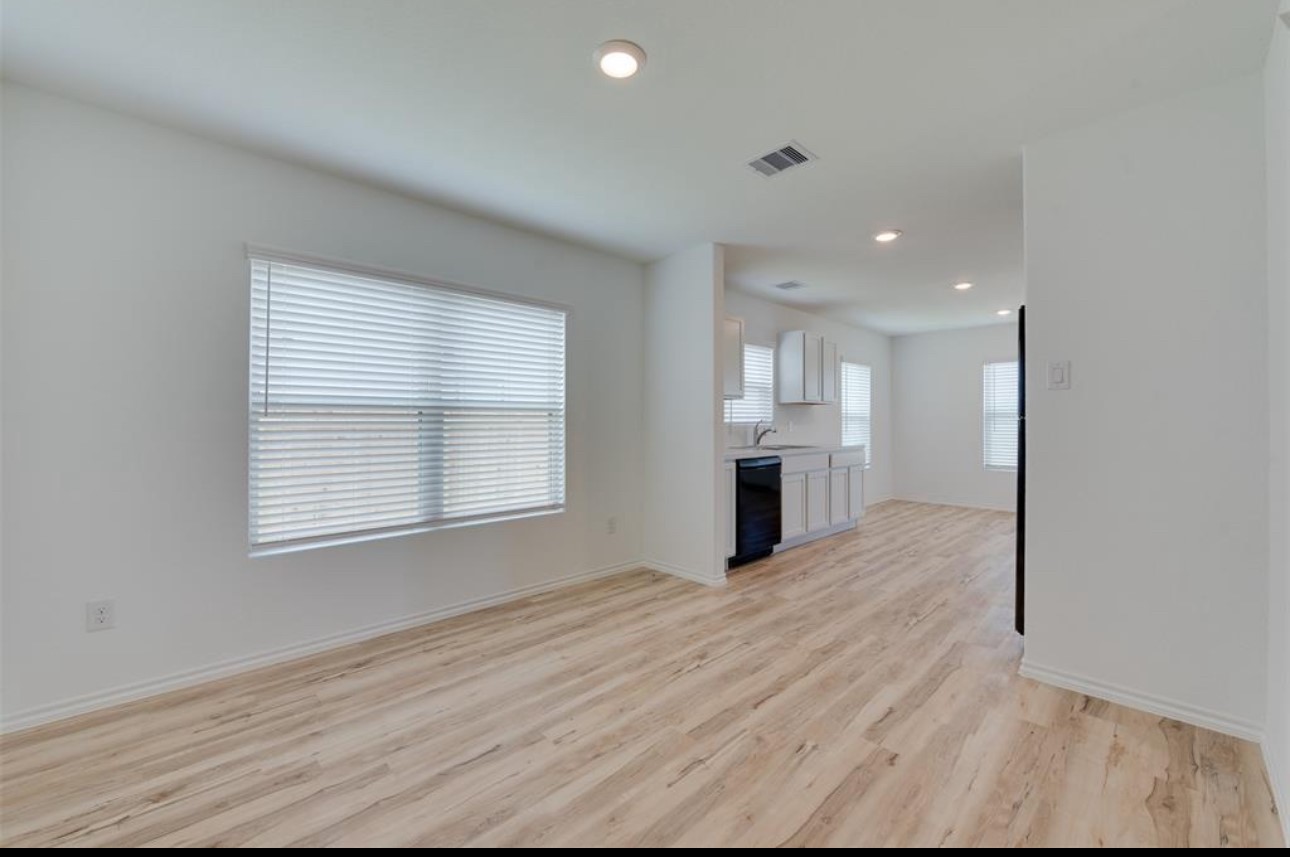 11020 South Lake Mist Lane Willis, TX 77318 - Photo 19 of 27 a view of an empty room with wooden floor and a window
