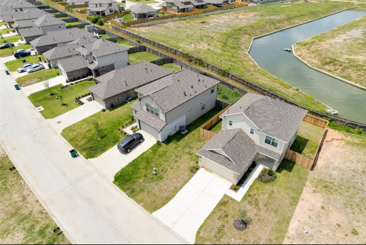 11020 South Lake Mist Lane Willis, TX 77318 - Photo 24 of 27 an aerial view of a house with a ocean view