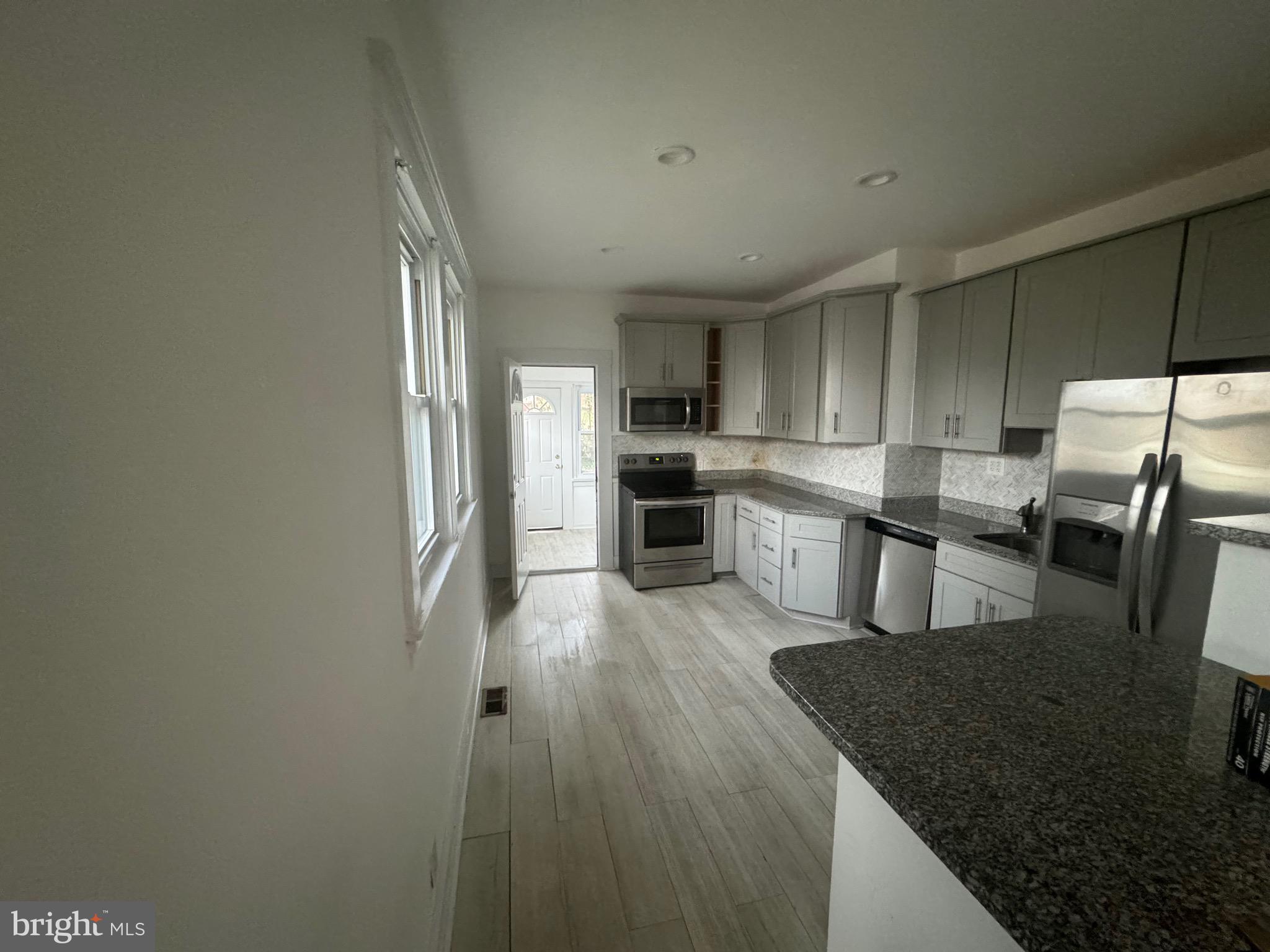 6203 McClean Boulevard Baltimore, MD 21214 - Photo 6 of 26 a kitchen with stainless steel appliances granite countertop a sink stove and refrigerator