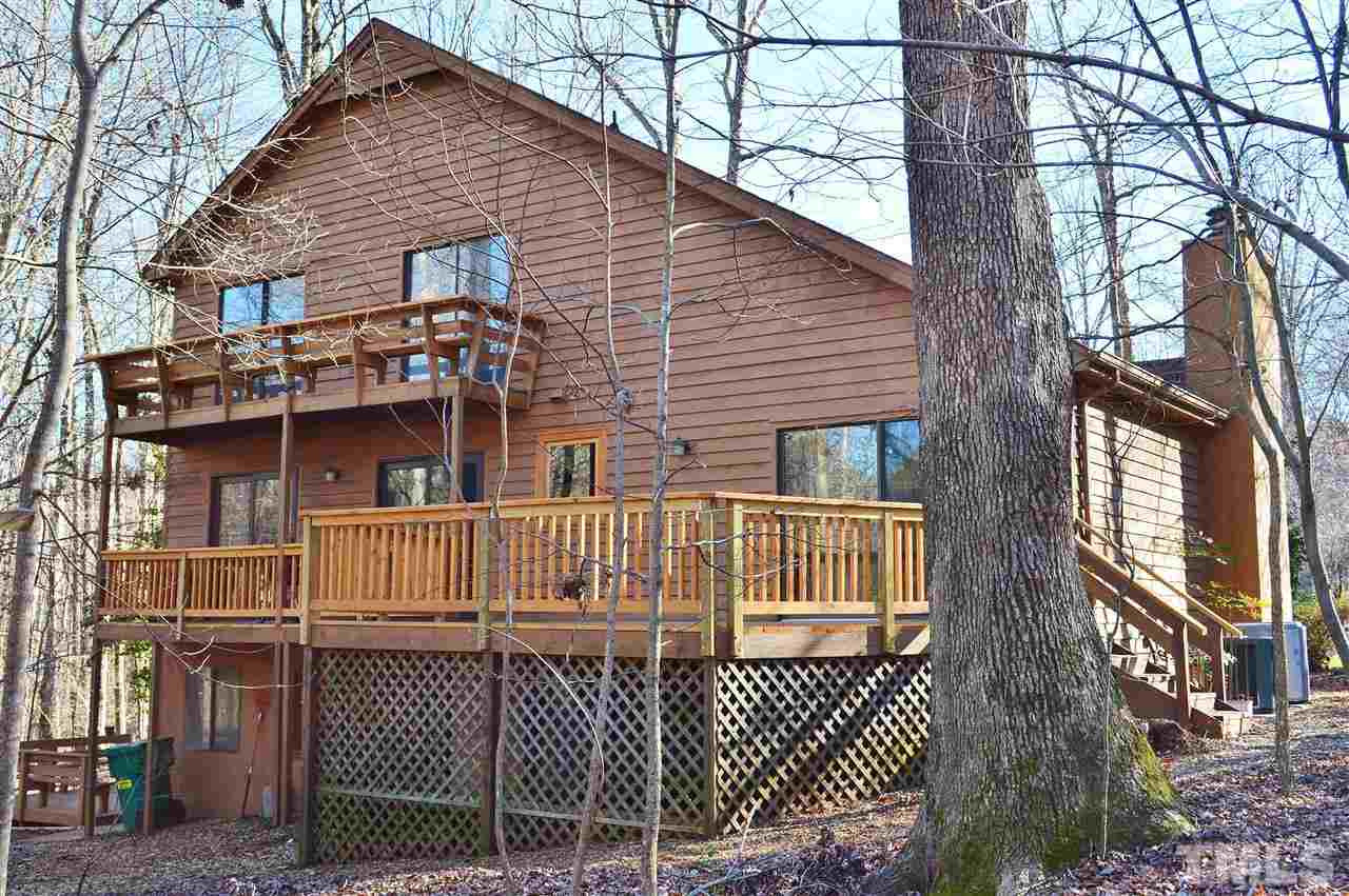 5200 Caber Road Raleigh, NC 27613 - Photo 25 of 25 View of the back of the home showing the multiple decking where you can enjoy the lovely wooded and landscaped lot. Much of the decking is new and it is all in excellent condition. Rear Elevation