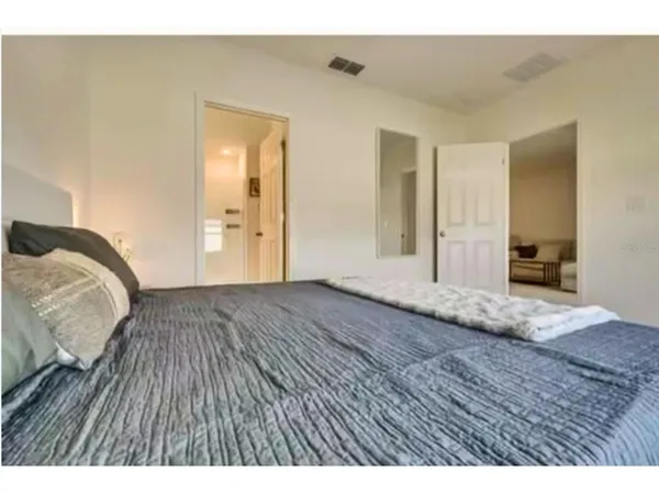 a view of bedroom with wooden floor