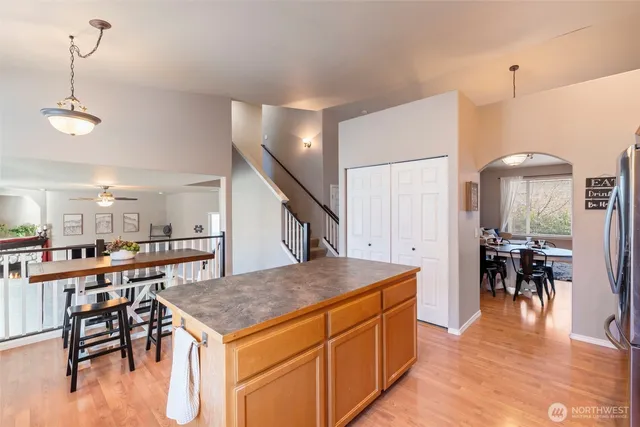 a kitchen with stainless steel appliances granite countertop a sink dishwasher stove top oven and refrigerator