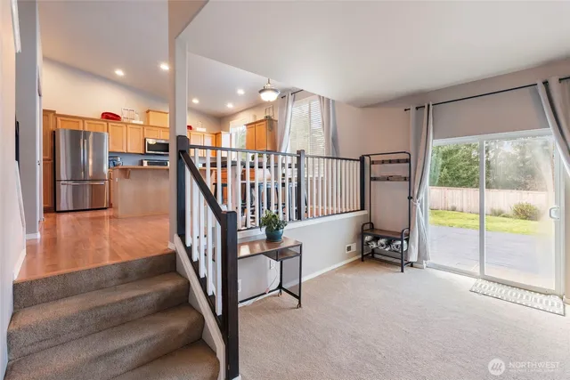 a living room with furniture a fireplace and a large window