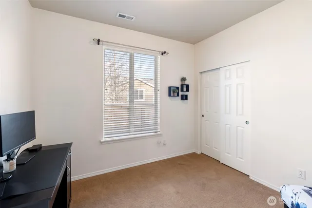 a bedroom with a bed and a dresser