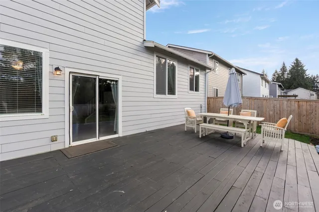 a view of a backyard with potted plants and wooden fence