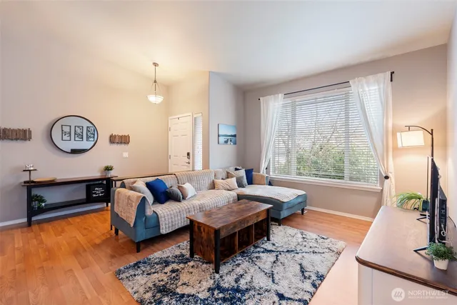 a living room with furniture a table and chairs
