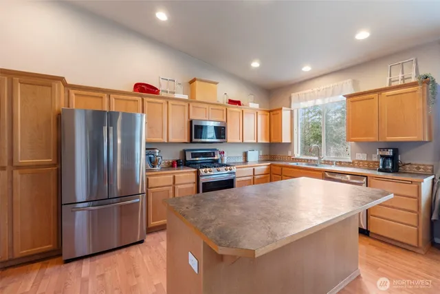 a kitchen with refrigerator a sink and cabinets