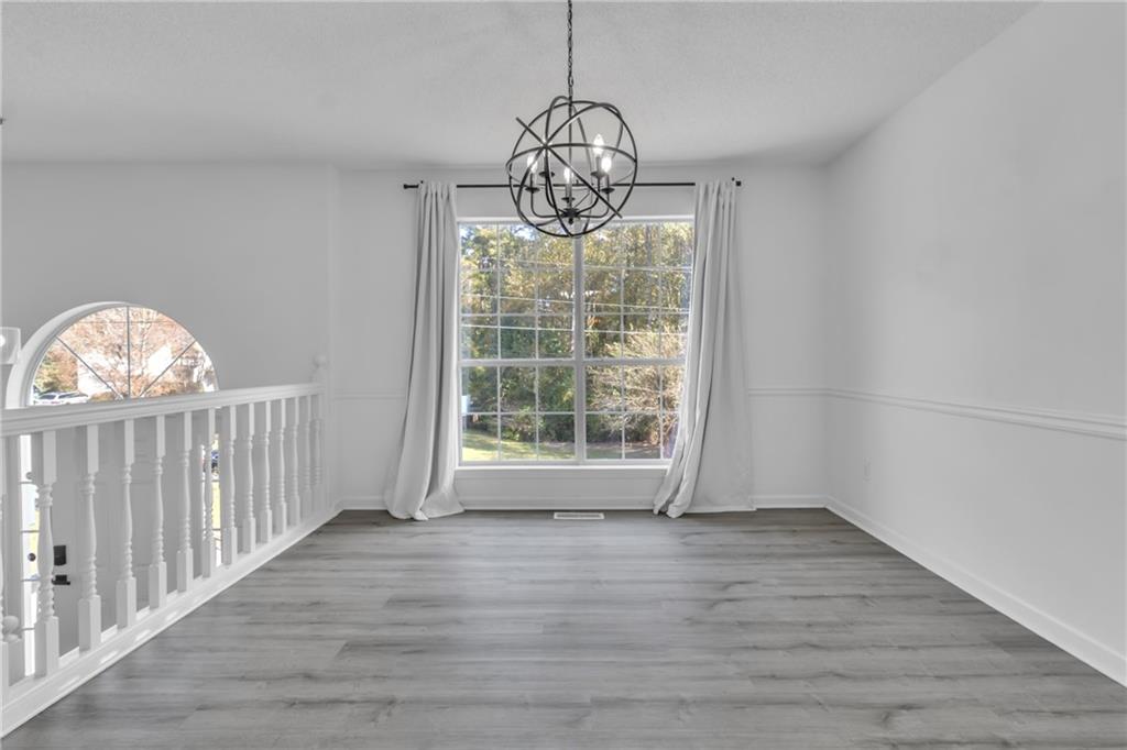 3985 Countryside Way Southwest Snellville, GA 30039 - Photo 11 of 40 a view of empty room with wooden floor and fan