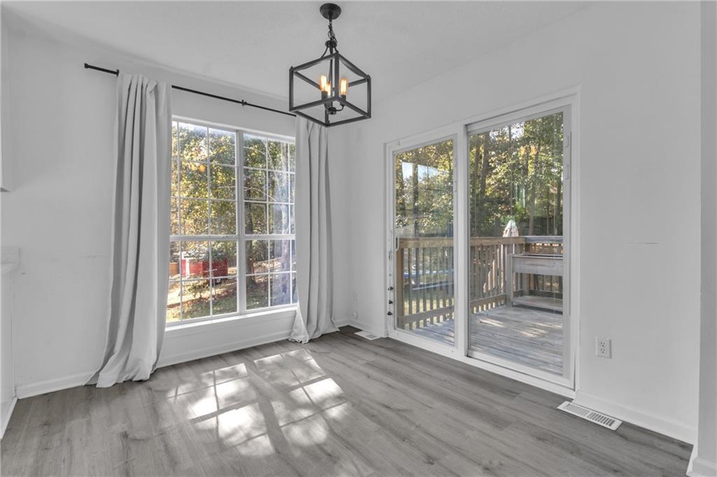 3985 Countryside Way Southwest Snellville, GA 30039 - Photo 12 of 40 a view of an empty room with wooden floor and a window