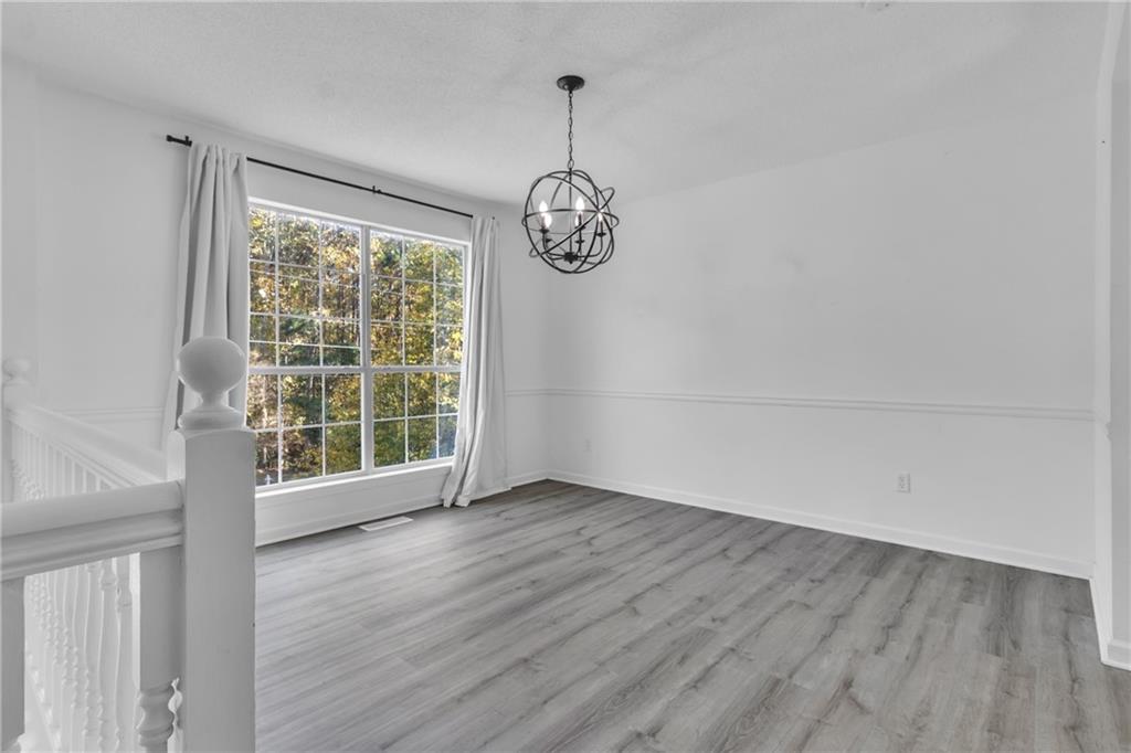 3985 Countryside Way Southwest Snellville, GA 30039 - Photo 13 of 40 a view of an empty room with wooden floor and a window