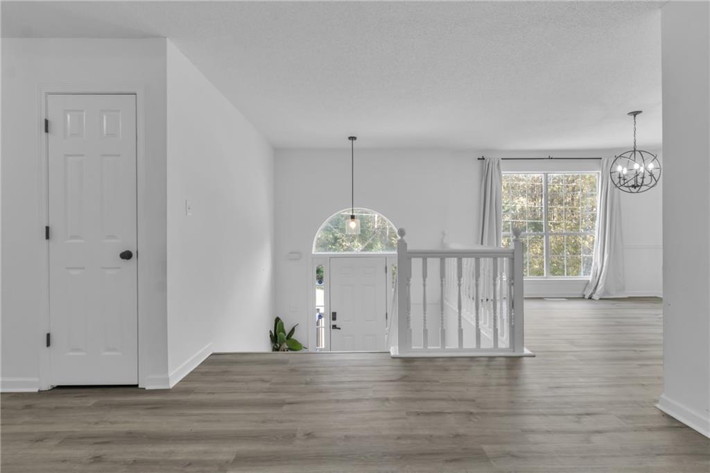 3985 Countryside Way Southwest Snellville, GA 30039 - Photo 14 of 40 a view of an empty room with wooden floor and a window