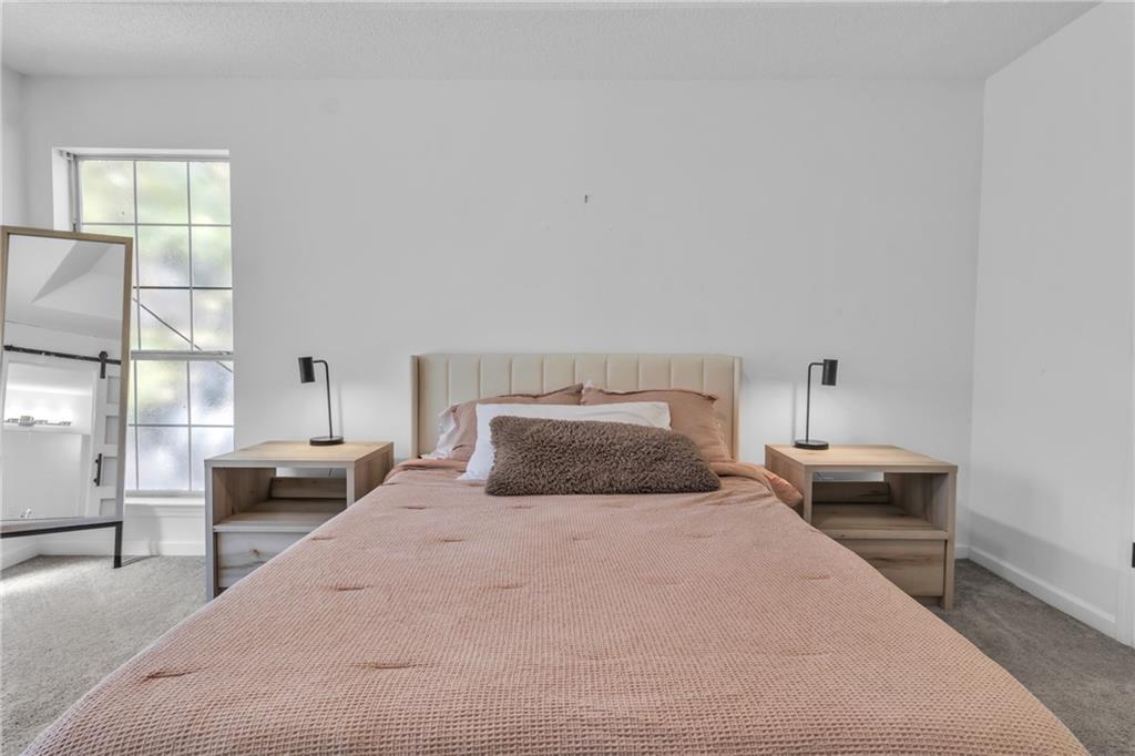 3985 Countryside Way Southwest Snellville, GA 30039 - Photo 16 of 40 a bedroom with a bed and furniture