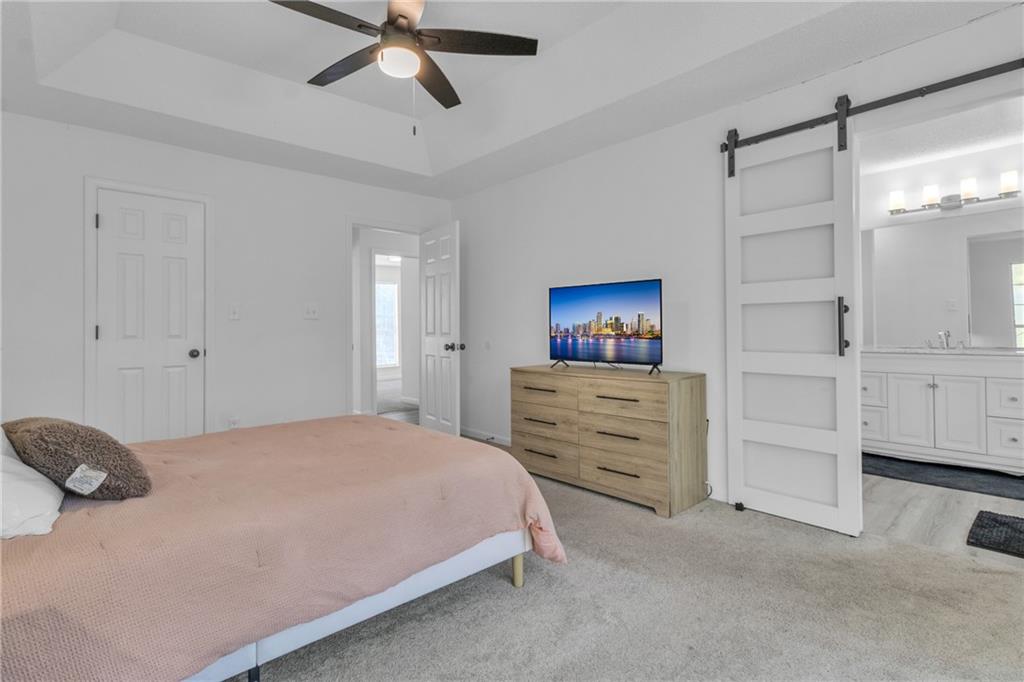 3985 Countryside Way Southwest Snellville, GA 30039 - Photo 17 of 40 a bedroom with a bed and a cabinets