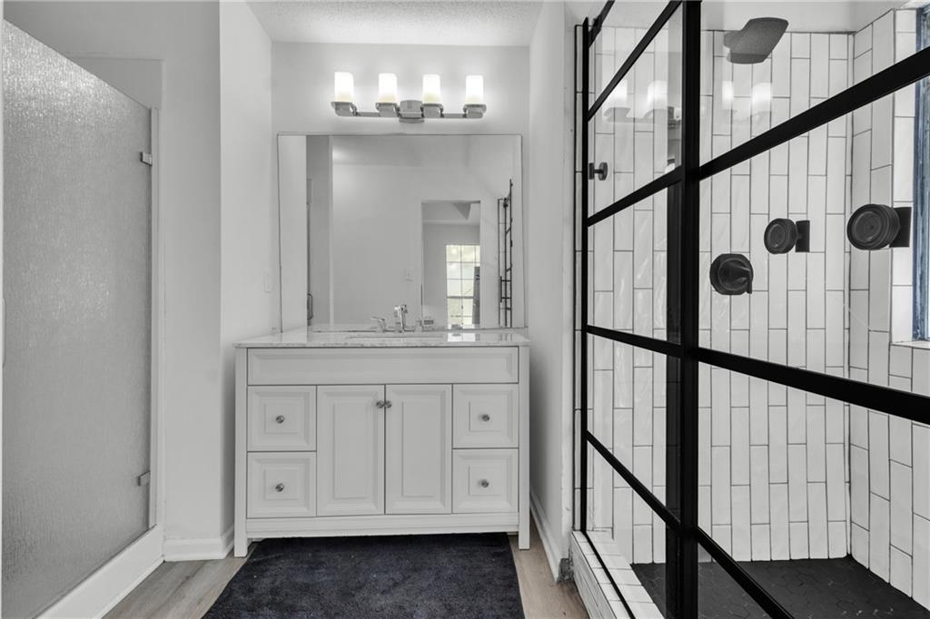 3985 Countryside Way Southwest Snellville, GA 30039 - Photo 19 of 40 a bathroom with a double vanity sink and a mirror