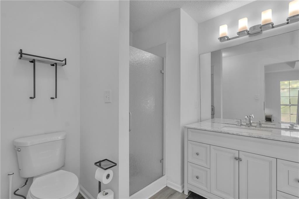 3985 Countryside Way Southwest Snellville, GA 30039 - Photo 21 of 40 a bathroom with a toilet a sink a vanity and mirror