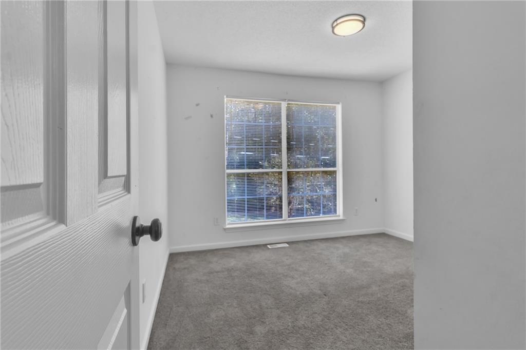 3985 Countryside Way Southwest Snellville, GA 30039 - Photo 22 of 40 an empty room with windows