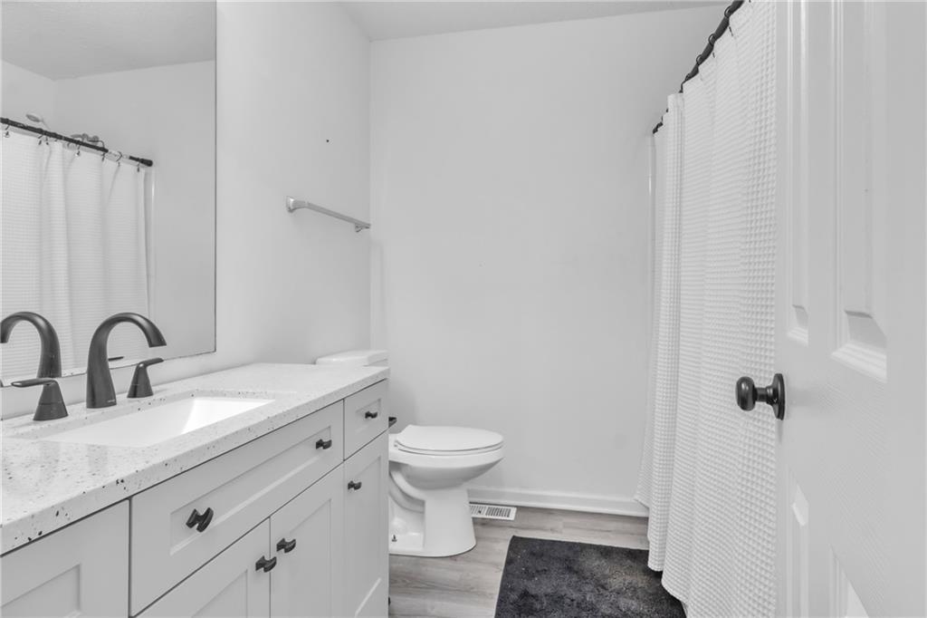 3985 Countryside Way Southwest Snellville, GA 30039 - Photo 24 of 40 a bathroom with a granite countertop sink toilet and shower