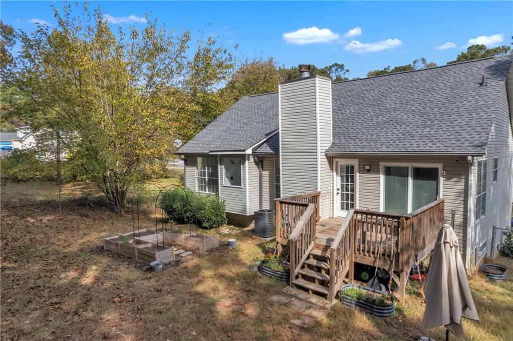 3985 Countryside Way Southwest Snellville, GA 30039 - Photo 37 of 40 a view of a house with a chairs in patio