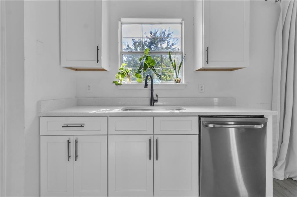 3985 Countryside Way Southwest Snellville, GA 30039 - Photo 6 of 40 a kitchen with a sink cabinets and window