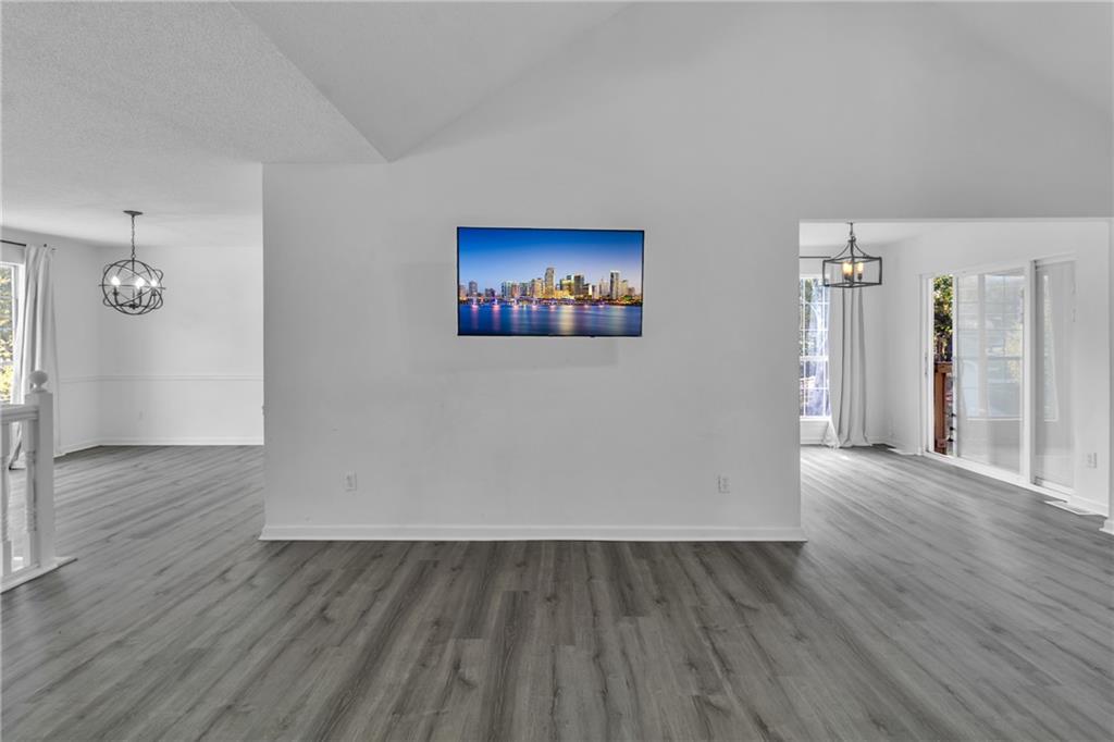 3985 Countryside Way Southwest Snellville, GA 30039 - Photo 9 of 40 an empty room with wooden floor and windows