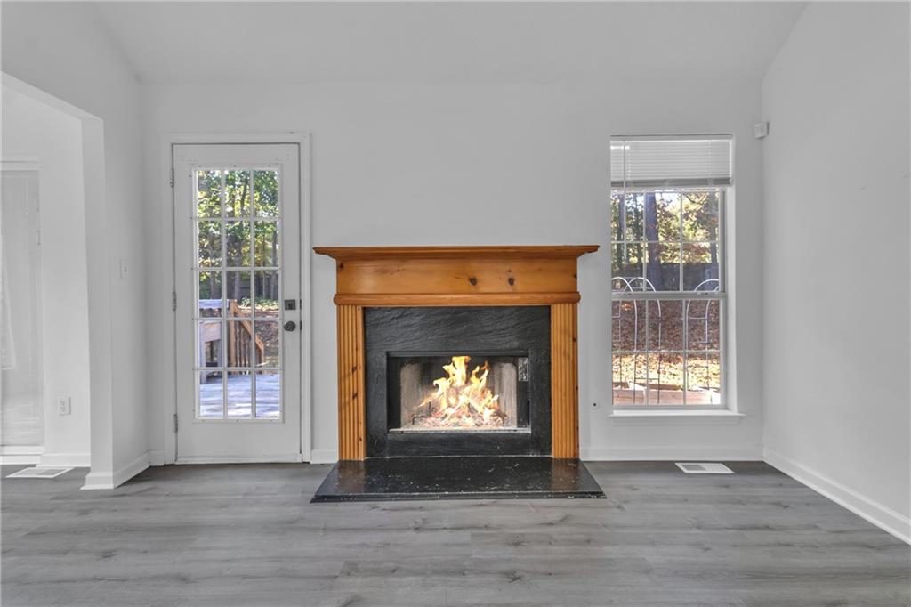 3985 Countryside Way Southwest Snellville, GA 30039 - Photo 10 of 40 a living room with a fireplace and a window