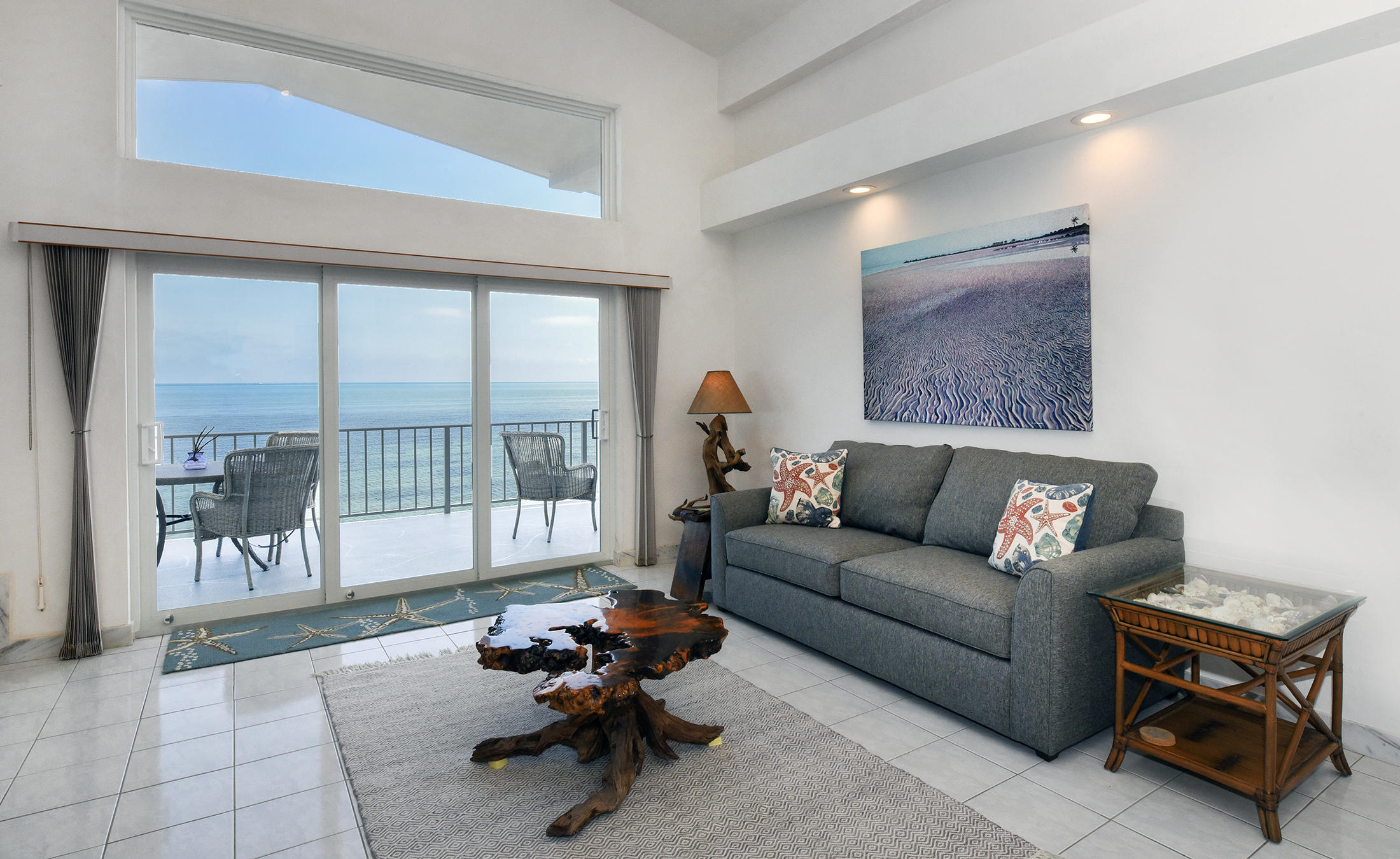 161-154 Sunset Drive Islamorada, FL 33036 - Photo 16 of 38 a living room with furniture and a floor to ceiling window