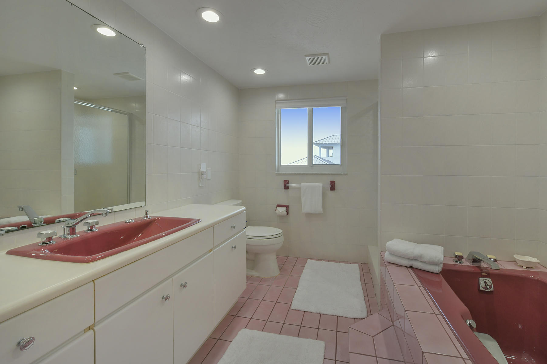 161-154 Sunset Drive Islamorada, FL 33036 - Photo 20 of 38 a spacious bathroom with a granite countertop sink a toilet and a mirror